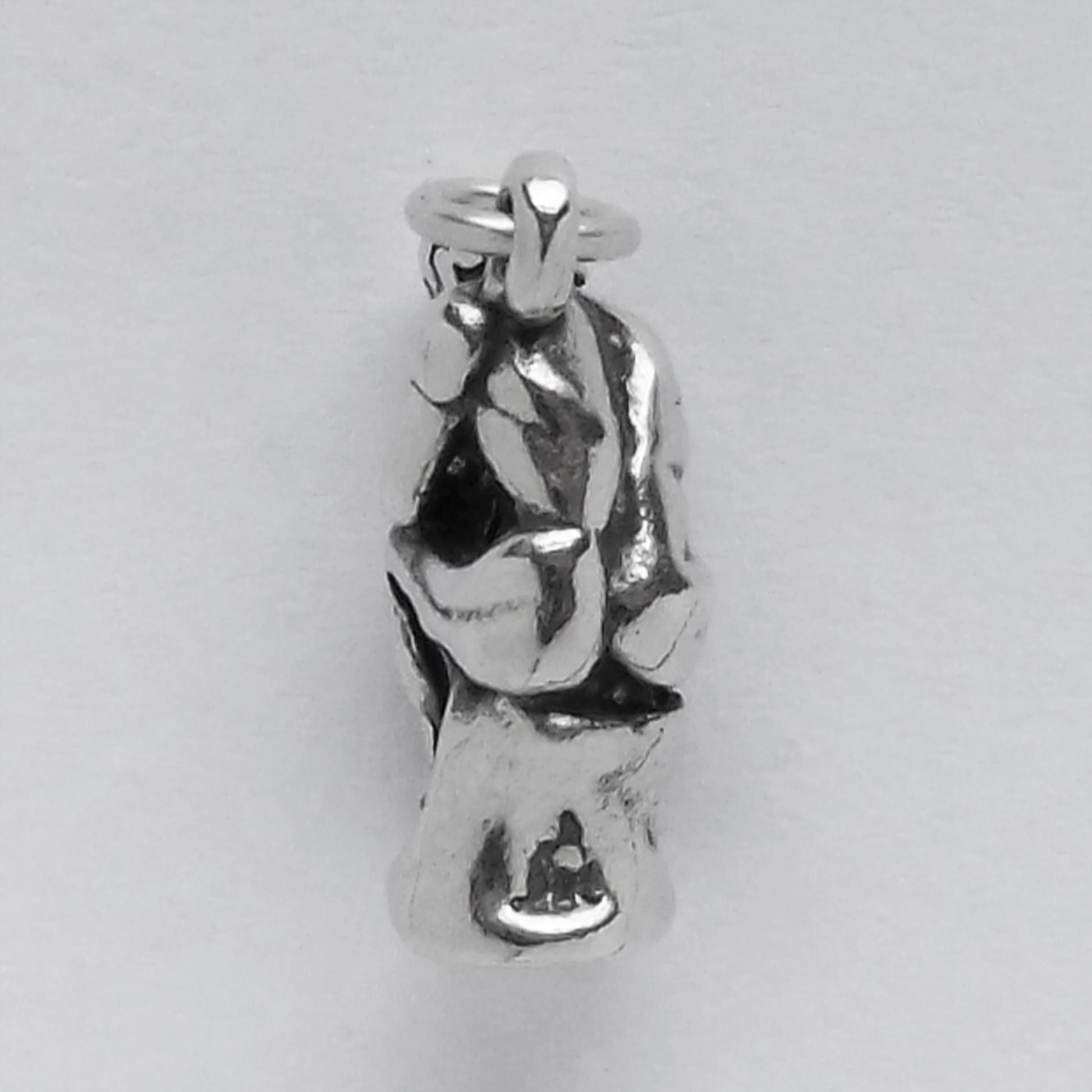 back view of silver the thinker sculpture charm on grey background