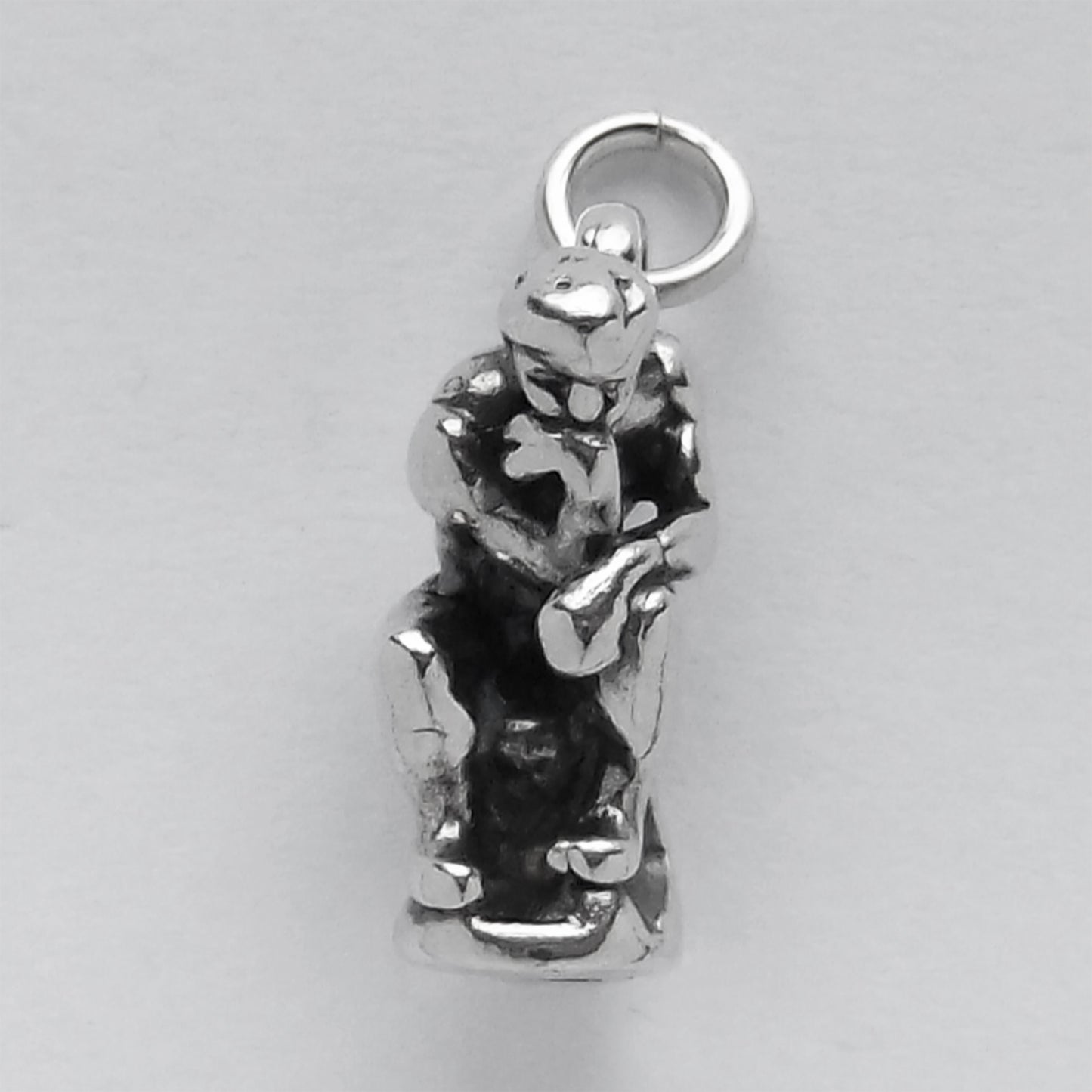 front view of the thinker sculpture charm on grey background