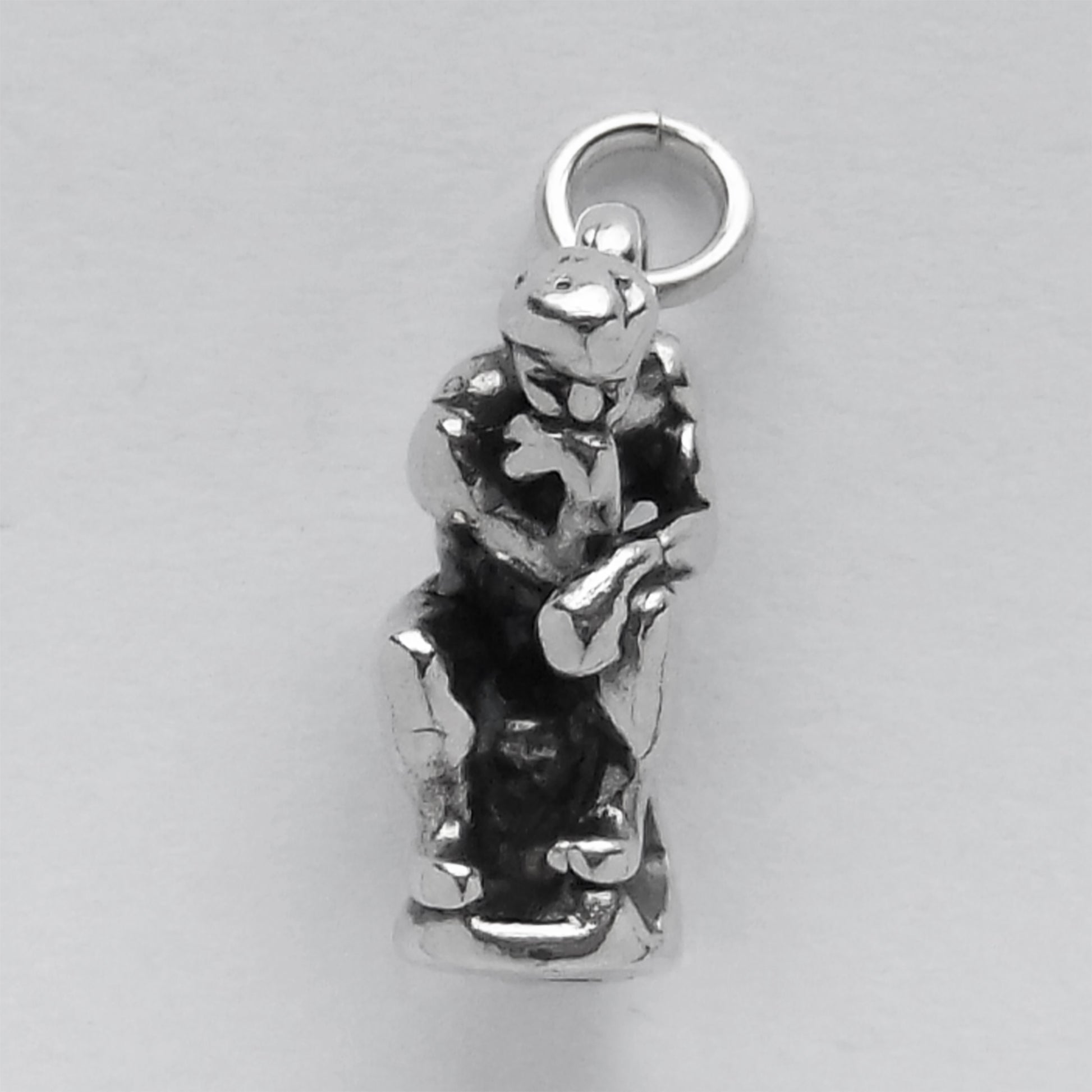 front view of the thinker sculpture charm on grey background