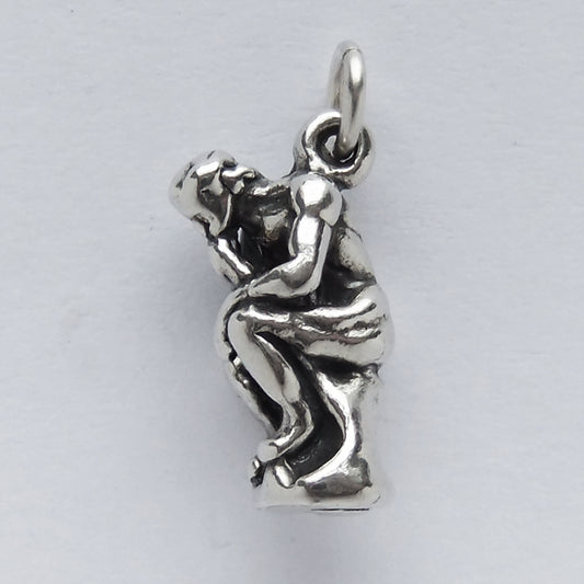 silver the thinker sculpture charm on light grey background