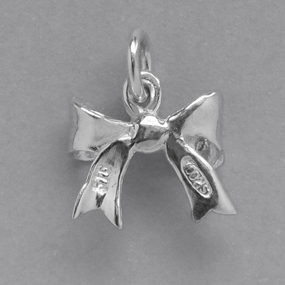 silver bow charm on a grey background